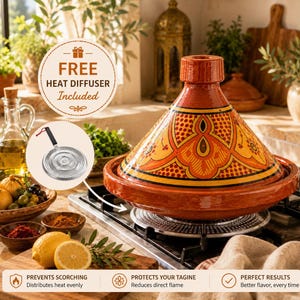 May include: A vibrant, orange and yellow Moroccan tagine pot with a conical lid, resting on a heat diffuser. The tagine features intricate geometric patterns. The image also includes a free heat diffuser.