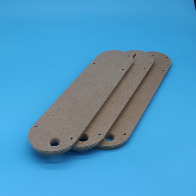 May include: Three brown wooden fan blades with holes for mounting. The blades are stacked on top of each other.