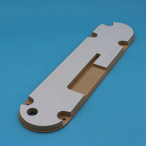 May include: A brown and white cardboard template with a cutout in the center. The template has the text "D-350/R 4.5" printed on it.