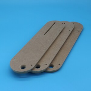 May include: Three brown wooden router templates with the text "ZERO CLEARANCE" engraved on them.