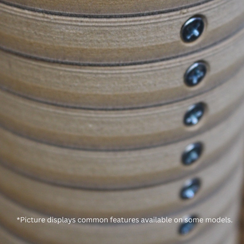 May include: Close-up of a stack of light brown wooden rings, each secured with a silver screw. The rings have a textured surface and are arranged in a cylindrical shape. The text at the bottom says "Picture displays common features available on some models."