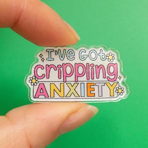May include: A clear acrylic sticker with the text "I've got crippling anxiety" in colourful letters with a daisy design around the text.