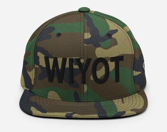 May include: A camouflage green and brown baseball cap with a black embroidered logo that says "WIYOT".