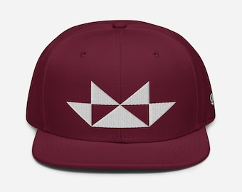 May include: A maroon and white baseball cap with a geometric design on the front. The design is made up of white triangles that form a boat shape.