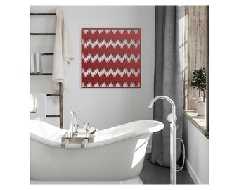 May include: A red metal wall art piece with a geometric pattern of white zigzags. The art is hanging on a white wall in a bathroom setting.