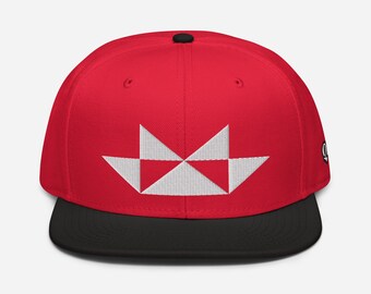May include: A red and black baseball cap with a white geometric design on the front.