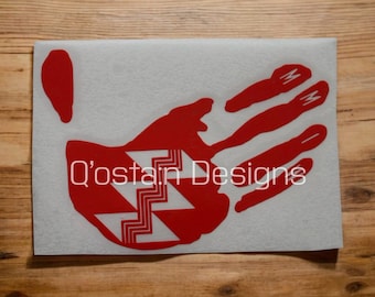 May include: Red handprint decal with a white geometric pattern in the center. The decal has the text "O'stain Designs" printed on it.