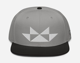 May include: A gray and black baseball cap with a white geometric design on the front.