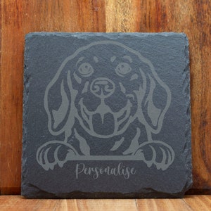 May include: Black and white engraved image of a Labrador Retriever dog on a black slate coaster. The text "Personalise" is below the image.