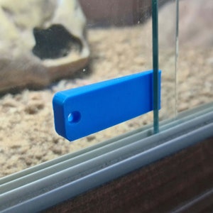 May include: A bright blue plastic wedge shaped tool for separating glass panels. The tool is designed to fit between the glass panels and help to separate them.