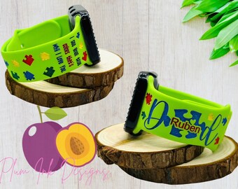 May include: Two green Apple Watch bands with a puzzle piece design. One band says "I see your heart's colors that's why I love you." The other band says "Dad" with a puzzle piece and the name "Ruben".