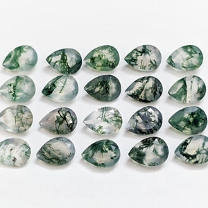 May include: Twenty pear-shaped green moss agate gemstones. The stones are translucent with a white background and green moss-like inclusions.