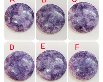 May include: Six round, purple and white, polished stones with a marbled pattern. The stones are labeled A through F.