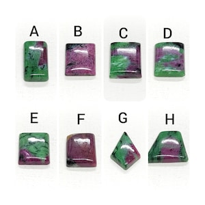 May include: Eight different cut gemstones, labeled A through H, with varying shades of green and pink. The gemstones are displayed on a white background.