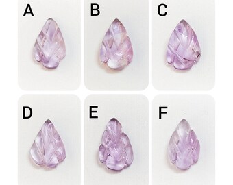 May include: Six carved amethyst leaf pendants, labelled A to F, on a white background.