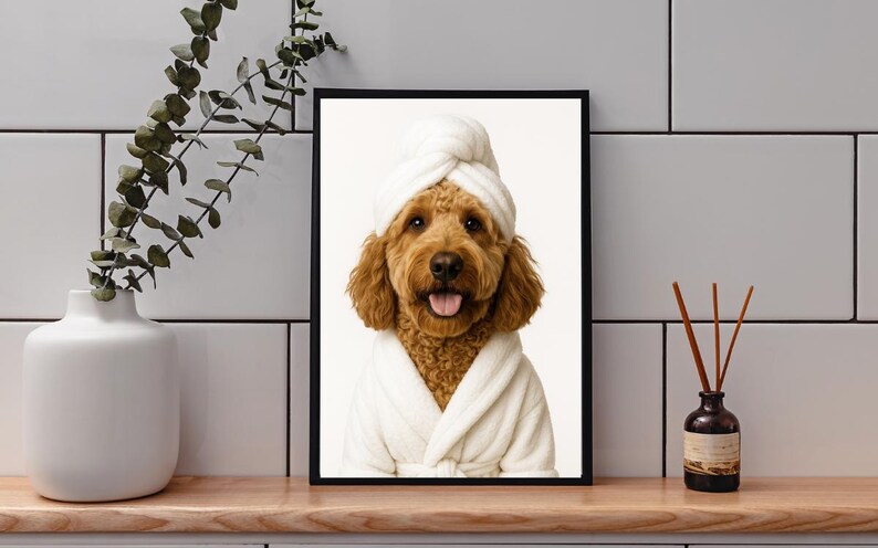 May include: Framed print featuring a golden doodle dog wearing a white spa robe and towel. The dog is smiling with its tongue out. The image is set against a white background.