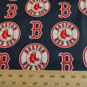 May include: Red, white, and blue fabric with a repeating pattern of the Boston Red Sox logo. The logo features a baseball with two red baseball shoes, the words "Boston Red Sox", and a red "B".