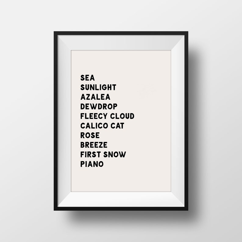 May include: A black framed print with a white background and black text. The text reads: "SEA SUNLIGHT AZALEA DEW DROP FLEECY CLOUD CALICO CAT ROSE BREEZE FIRST SNOW PIANO"