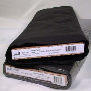 May include: Two rolls of black woven fusible fabric, 23 inches wide and 25 yards long, for sewing and tailoring. The fabric is 100% cotton and provides firm stability and support. The labels read "Bosal" and "Style #301".