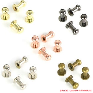 May include: Assortment of metal knobs in various finishes, including gold, silver, black, bronze, and rose gold. The knobs are small and round with a cylindrical base.