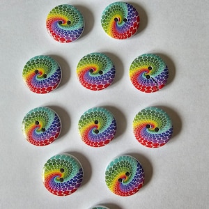 May include: Twelve colourful wooden buttons with a rainbow swirl design. Each button has two holes.