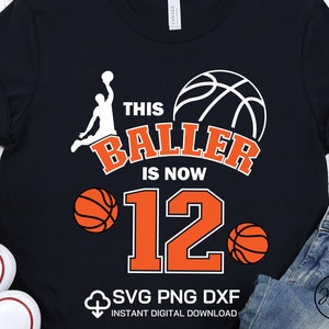 May include: A black t-shirt with a white basketball player silhouette, a basketball, and the text 