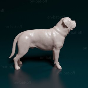 May include: A white, 3D printed model of a dog, possibly a bulldog, standing on a dark blue surface. The model is detailed and realistic, with visible fur and wrinkles.