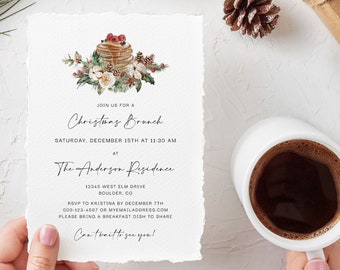 May include: A Christmas brunch invitation with a watercolor illustration of a stack of pancakes with berries and a sprig of greenery. The invitation text reads "Join us for a Christmas Brunch, Saturday, December 15th at 11:00 am at The Anderson Residence, 12345 West Elm Drive, Boulder, CO. RSVP to Kristina by December 17th, 000-123-4567 or myemailaddress.com. Please bring a breakfast dish to share. Can't wait to see you!"