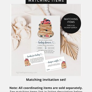 May include: A set of printable baby shower invitations featuring a pancake and blueberry theme. The invitation shows a stack of pancakes topped with blueberries and strawberries. The text on the invitation reads "Join us for a Pancakes & Pajamas Baby Shower to celebrate Gabriela & Baby Henderson". The invitation also includes the date, time, and location of the shower. The set also includes a "Books for Baby" card and a "Diaper Raffle" card.