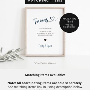 May include: A printable sign with a white background and a brown frame. The sign says "Favors" in a cursive font with a heart symbol. The text below says "Please take one. We're so happy you could be here to celebrate with us!" with a small heart symbol. The names "Emily & Ryan" are printed below the text. The sign also includes a black box with the text "Matching Items Type F132 In Shop Search".