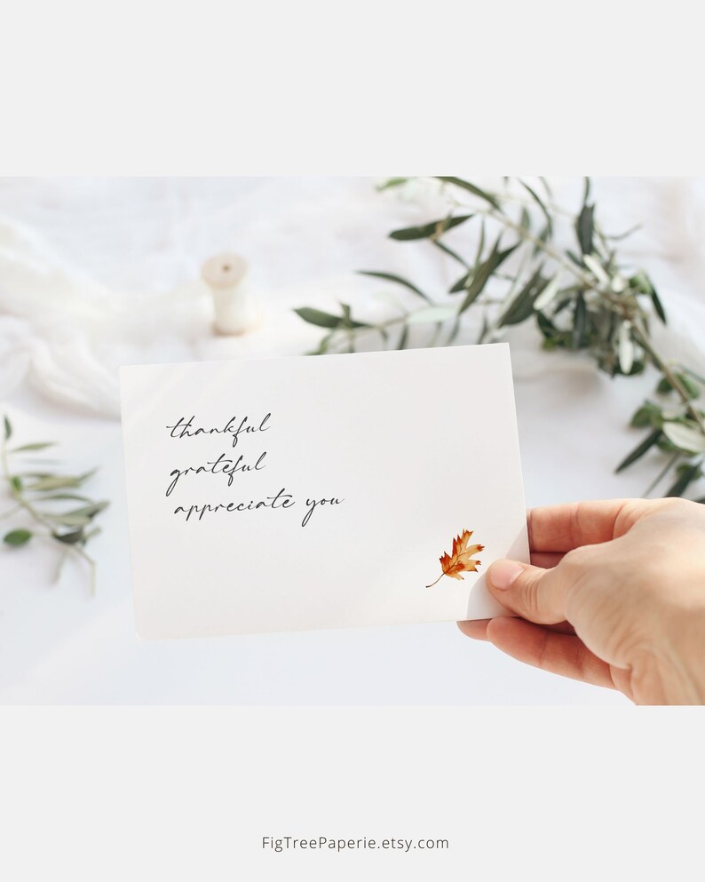 May include: A white card with the handwritten text "thankful grateful appreciate you" and a pressed, dried, orange leaf.