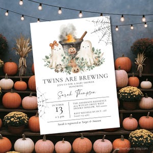 May include: A Halloween-themed baby shower invitation with the text "Twins are Brewing." The invitation features watercolor illustrations of ghosts, pumpkins, and a cauldron. The date is October 13th, with the time 2-5 pm.