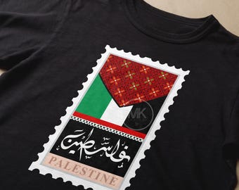 May include: Black t-shirt with a white stamp design featuring a Palestinian flag and the Arabic text "فلسطين" which translates to "Palestine".