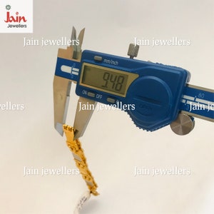 May include: A blue digital caliper measuring a gold chain bracelet. The caliper reads 9.48 mm. The image includes the text "Jain Jewellers".