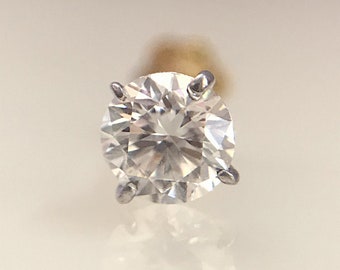 May include: A single round diamond solitaire set in a prong setting. The diamond is clear and sparkly.