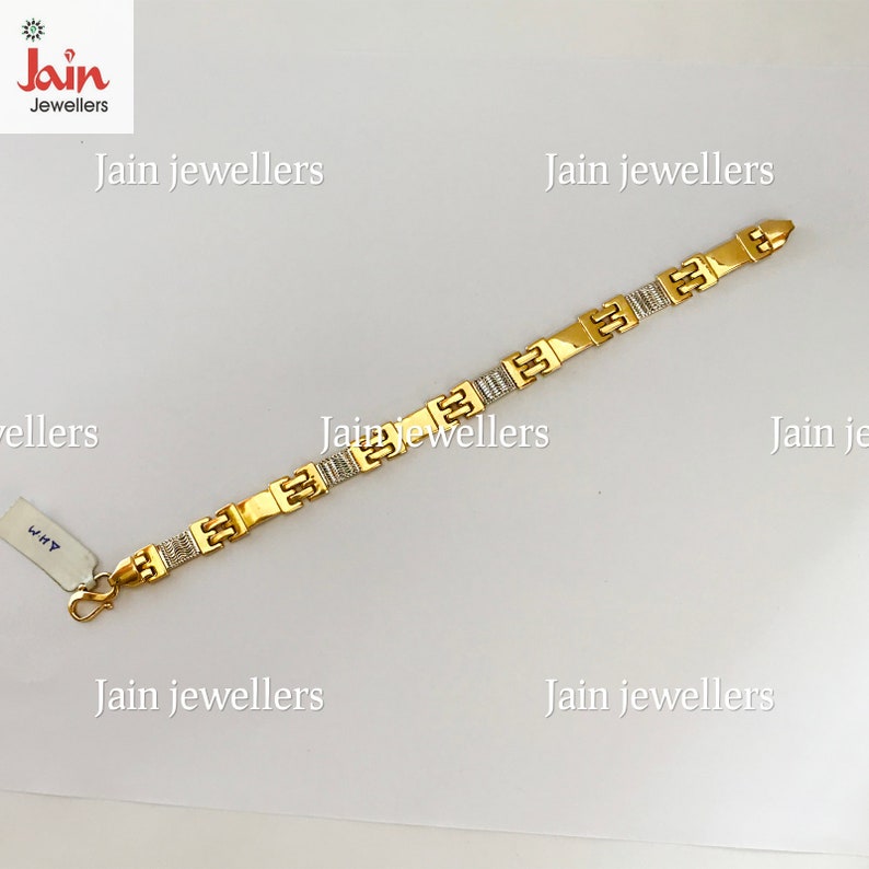 May include: A gold bracelet with a square link design. The bracelet has a polished finish and is decorated with small, clear stones.