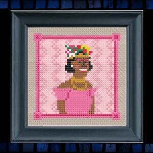 May include: A cross-stitch pattern of a woman with brown skin wearing a pink dress and a colorful flower crown. The background is pink with a white pattern.