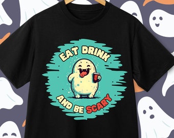 May include: Black t-shirt with a green and white graphic of a cartoon ghost holding a cup of coffee. The text "Eat Drink And Be Scary" is written around the ghost.