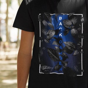 May include: Black t-shirt with a graphic print of blue leaves and the word "BACKGARDEN" in blue letters.