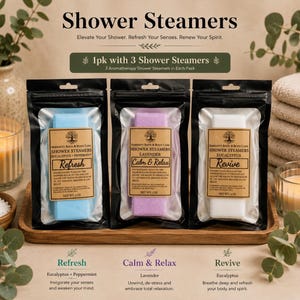 May include: Three rectangular shower steamers in individual black pouches. The blue steamer is labeled Refresh, the purple is labeled Calm & Relax, and the white is labeled Revive. Each label includes the text Serenity Bath & Body Care and 3 oz.