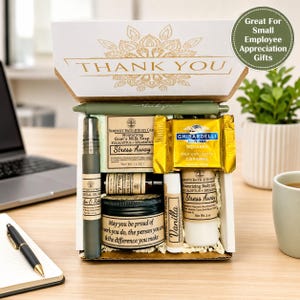 May include: A gift box labeled THANK YOU containing a green pen, a bar of eucalyptus and spearmint goat's milk soap, a Ghirardelli milk chocolate caramel square, a spray bottle, a jar of body cream, a vanilla lip balm, and a body lotion bottle.