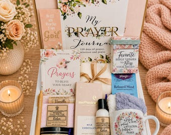 May include: A gift box containing a My Prayer Journal, a book of Bible verses, a Prayers book, a vanilla lip balm, goat's milk soap, a Relaxing Lavender candle, a milk chocolate bar, a Relax lotion, a pen, and a mug with floral text.