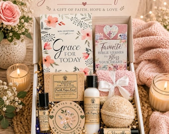 May include: A gift box containing a Grace for Today devotional book, a Favorite Bible Verses card, a bar of goat's milk soap, a bottle of body lotion, a body oil roller, a scented soy candle, a bath bomb, a vanilla lip balm, and fuzzy socks.