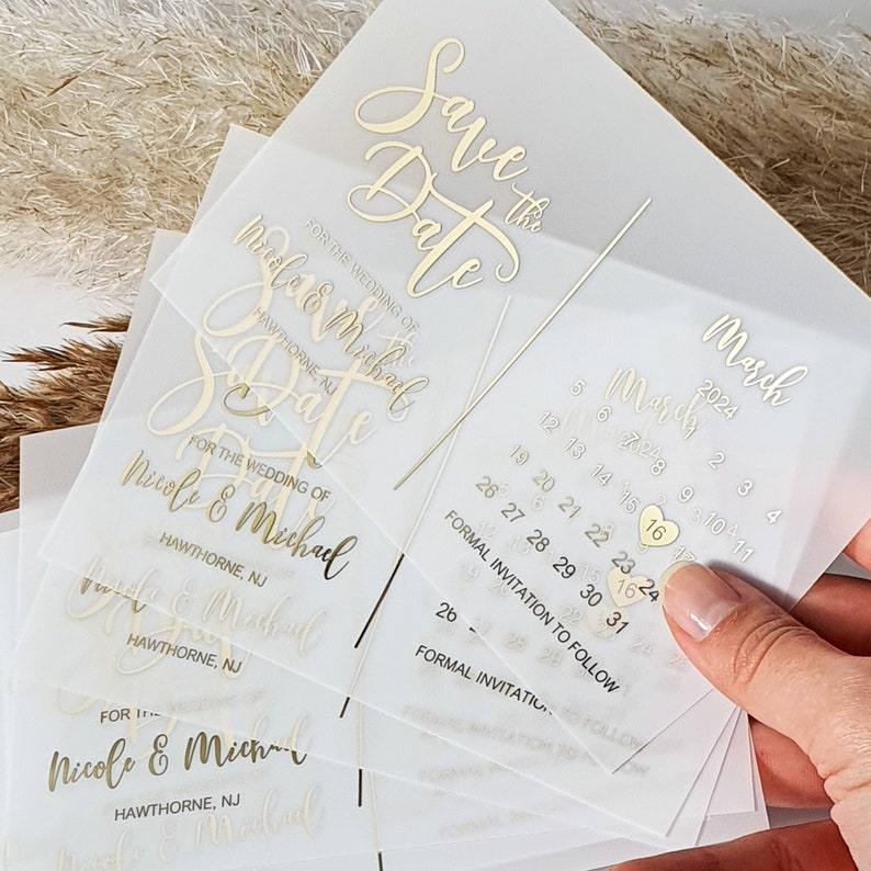 May include: Save the Date cards with gold foil lettering for a wedding in March. The cards feature a calendar with the date highlighted and the text "Save the Date" and "Formal Invitation to Follow".