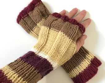 May include: A pair of striped fingerless gloves in shades of burgundy, brown, beige, and white. The gloves are knitted and have a ribbed texture.