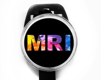 May include: A black badge holder with a round, clear, silver-rimmed badge that says "MRI" in rainbow-colored letters.