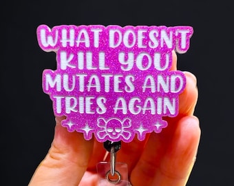 May include: Pink glitter badge holder with a white skull and crossbones and the text "What doesn't kill you mutates and tries again".