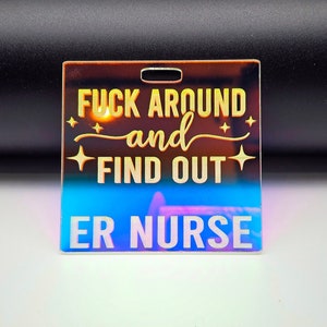 May include: A rainbow iridescent acrylic keychain with the text "F**k Around and Find Out ER Nurse".
