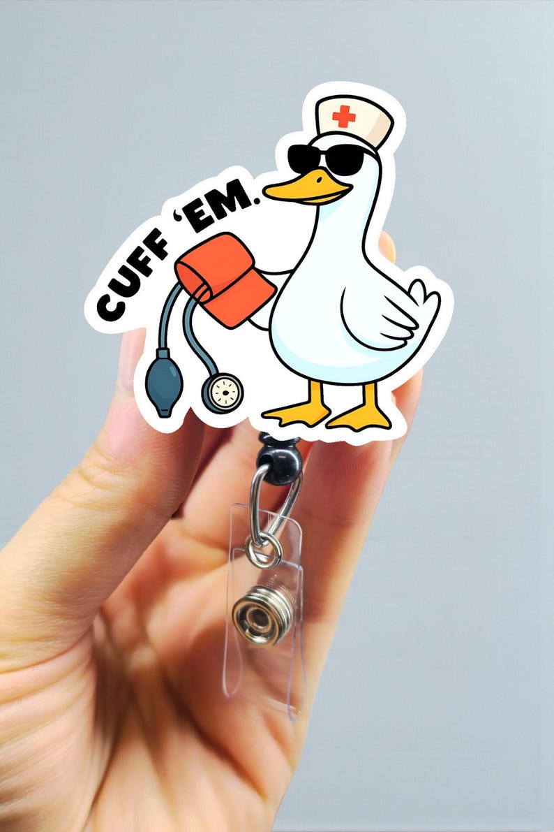 May include: A white badge reel featuring a cartoon goose wearing sunglasses and a nurse's hat, holding a blood pressure cuff. The text "CUFF 'EM" is printed on the badge reel.