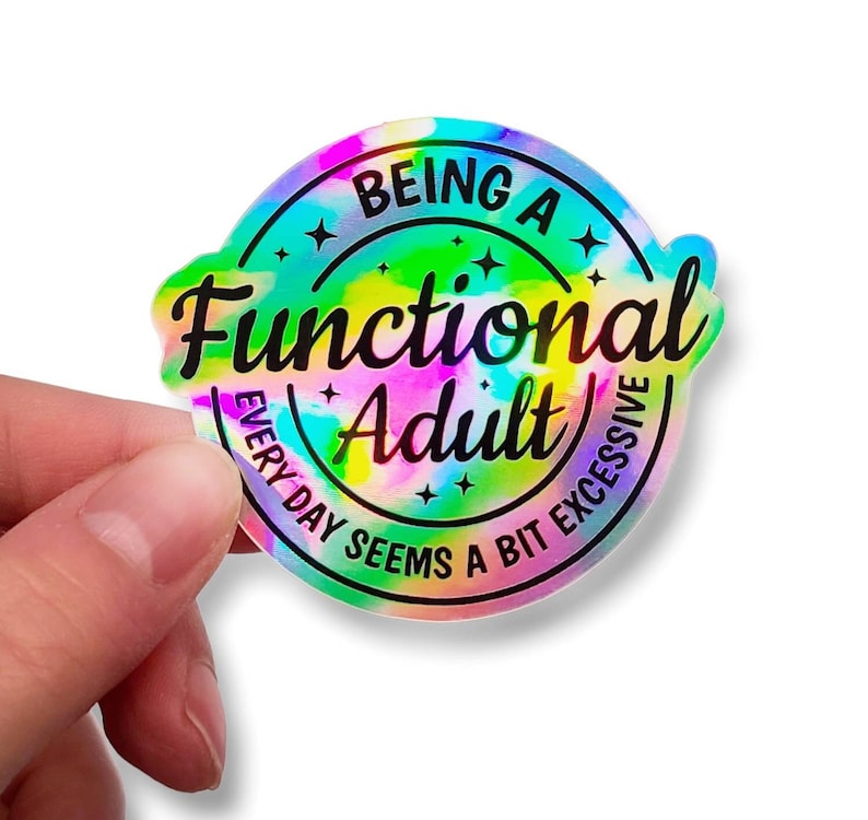 May include: A round sticker with a tie-dye background in shades of pink, blue, green, and yellow. The sticker says "Being a Functional Adult Every Day Seems a Bit Excessive" in black text.